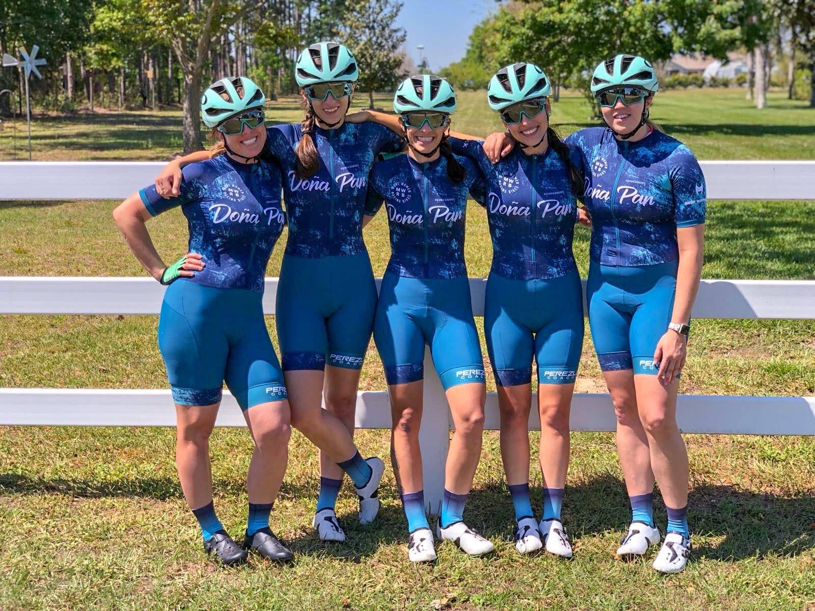 5 women in cycling gear smiling