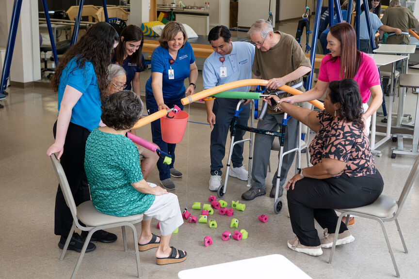 a group of people smiling and working together in the hope clinic.