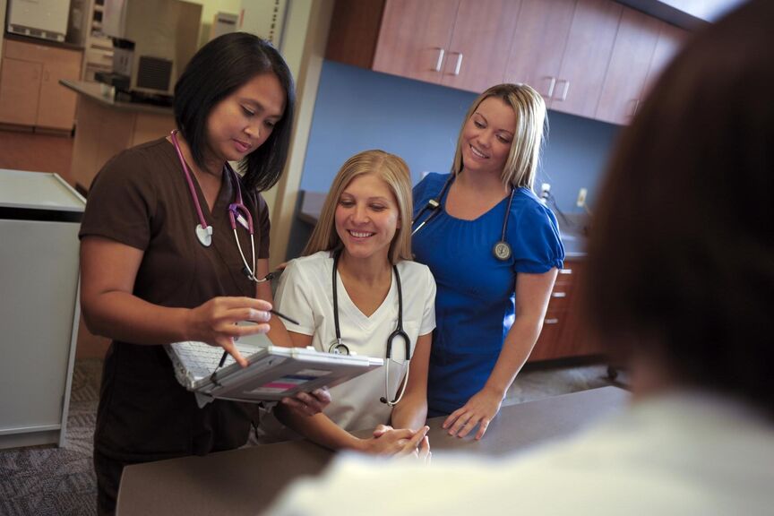 Nurses looking a a computer