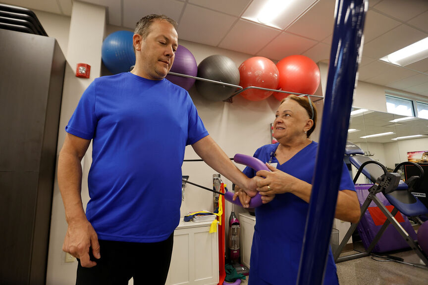 A patient works with an occupational therapist at AHU's Hope Clinic