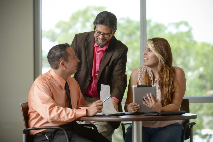 Two students and professor talking