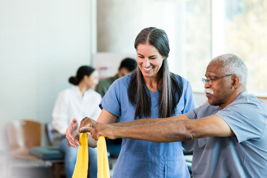 An occupational therapist works with a patient