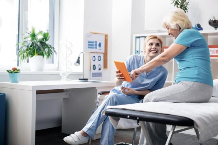 Nurse with patient looking at tablet