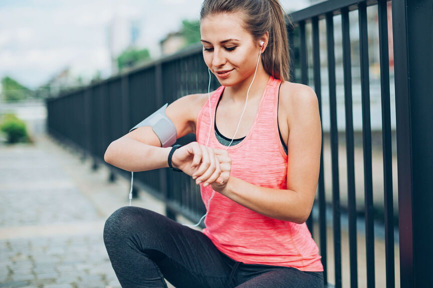 A runner checking her time