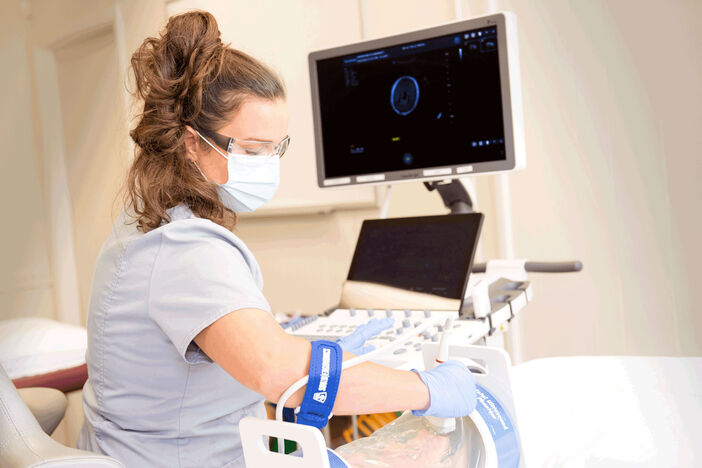 Female sonography student practicing scanning
