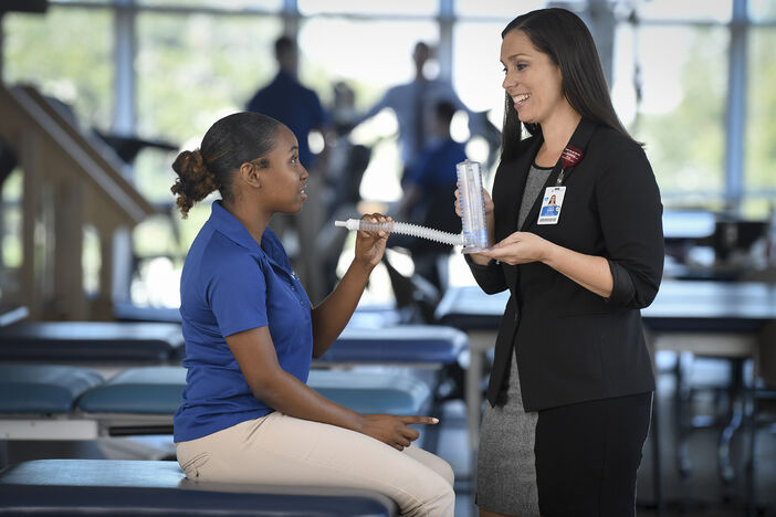 Physical Therapy students demonstrating breathing device