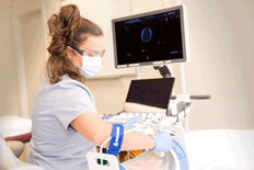 Female sonography student practicing scanning