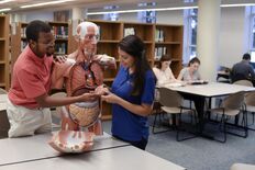 Students looking at anatomical model