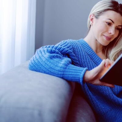 Young woman using a tablet on the couch