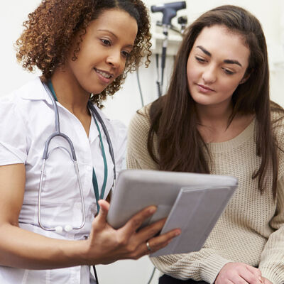 Nurse with patient using tablet