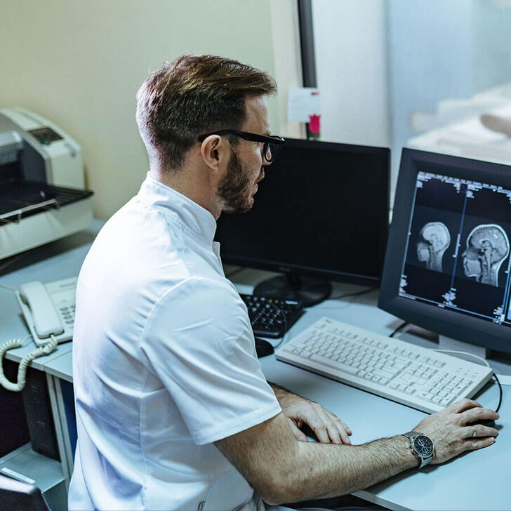 An MRI tech looking at a brain scan