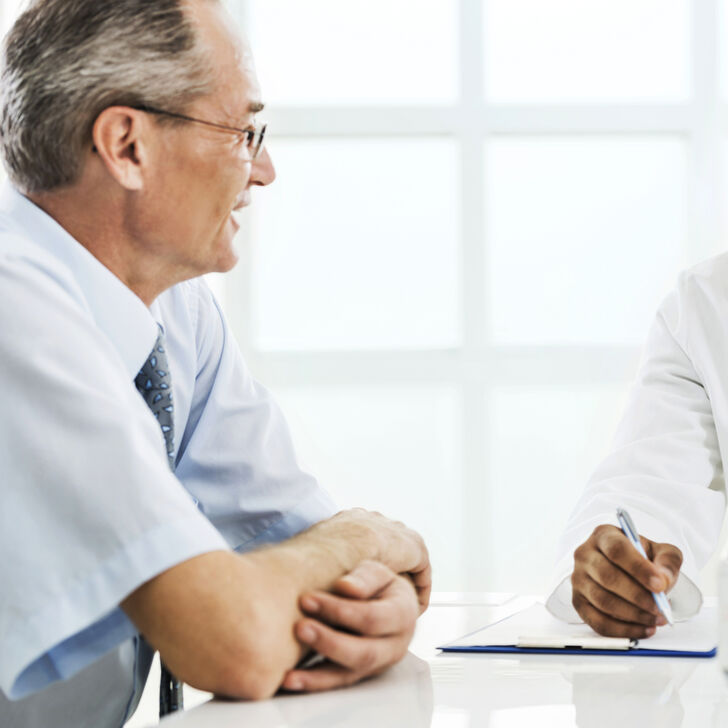 Older patient talking with doctor