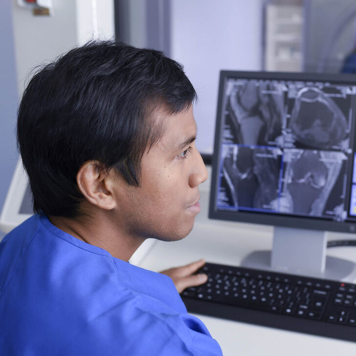 MRI Technician using a computer
