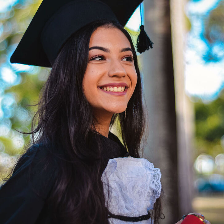 A female student in graduation regalia