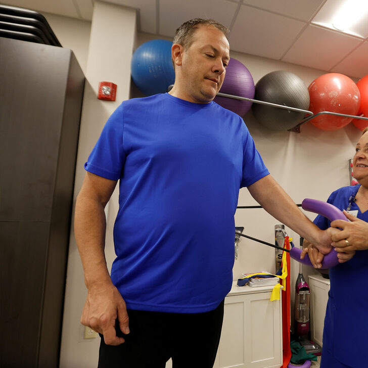 A patient works with an occupational therapist at AHU's Hope Clinic