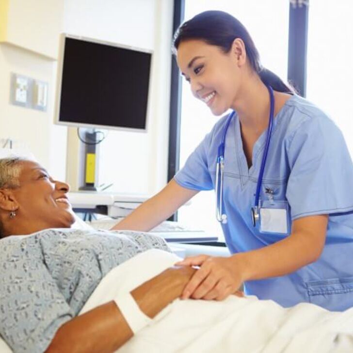 nurse-holds-hand-of-older-patient