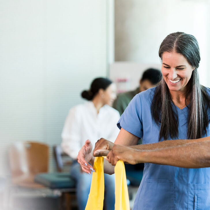 An occupational therapist works with a patient