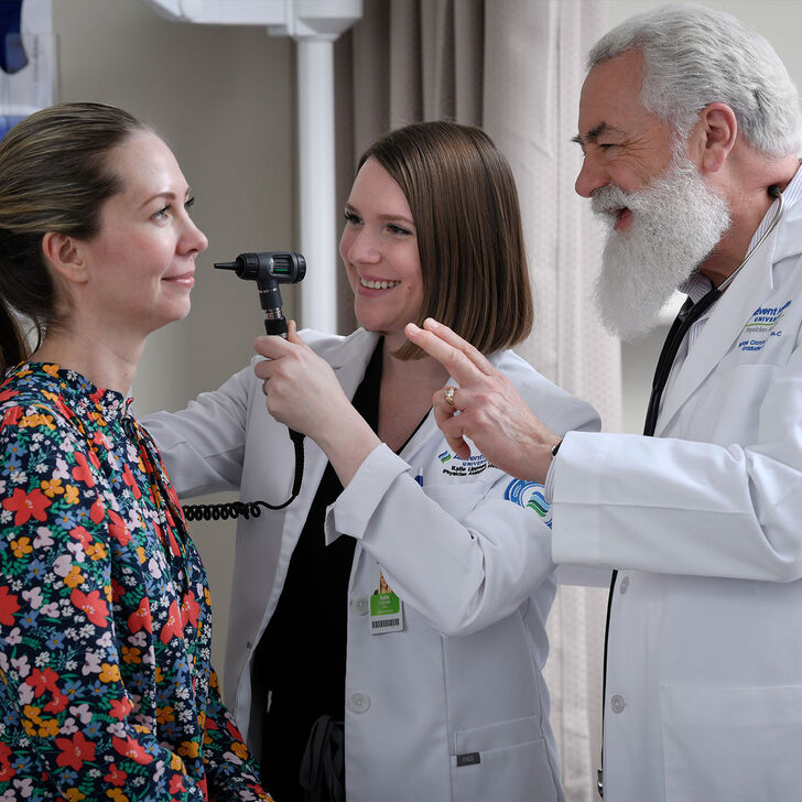 A student examines a patient under faculty supervision