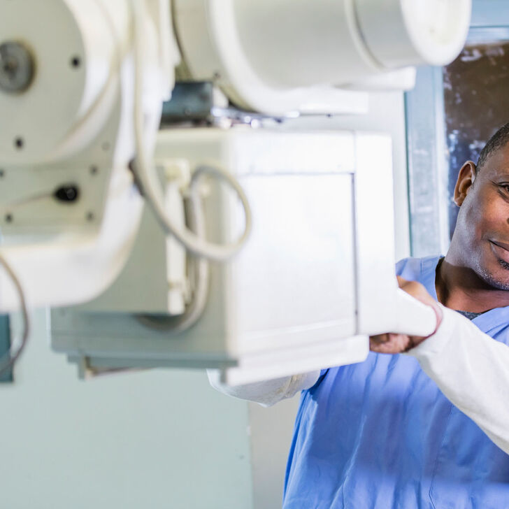 A male radiologic technologist getting ready to perform a scan.
