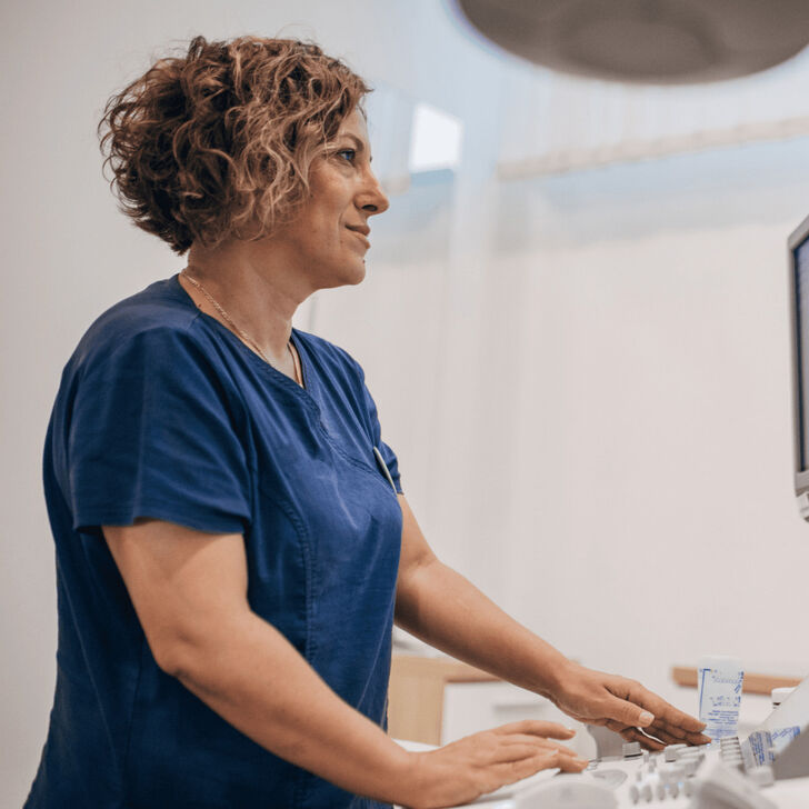 A healthcare worker looking at a computer display