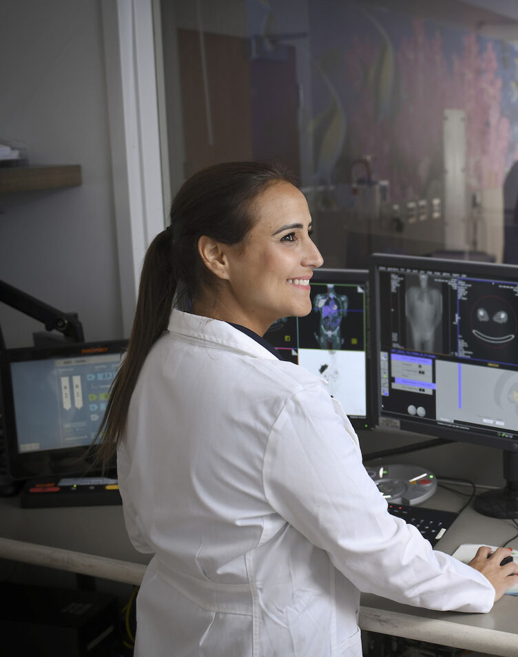 A nuclear medicine technologist conducting a PET scan
