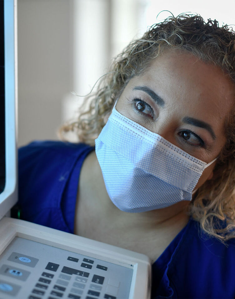 A female radiography student viewing a diagnostic image on a monitor