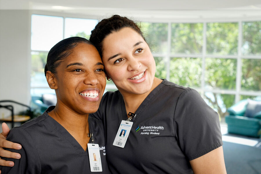two female AHU nursing students with their arms around each other